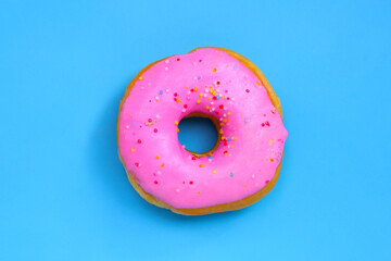 Pink donut on blue background.