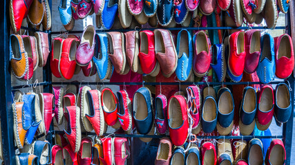 Traditional colorful shoes in the bazaar or market at Gaziantep City, Turkey. Colorful shoes texture pattern background. Variety of beautiful colorful leather shoes in India.