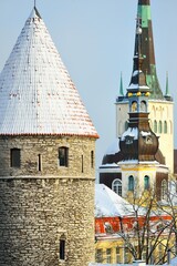 Close-up of the fortress tower and a spire of St. Olaf's Church. Tallinn old town after a blizzard....