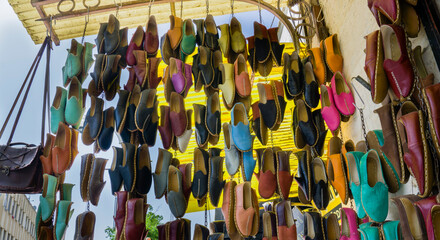 Traditional colorful shoes in the bazaar or market at Gaziantep City, Turkey. Colorful shoes texture pattern background. Variety of beautiful colorful leather shoes in India.