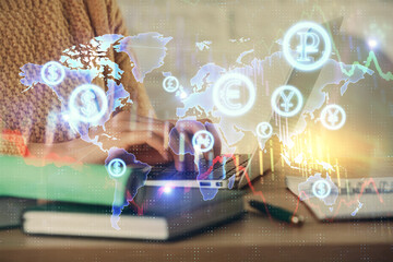 Double exposure of woman hands typing on computer and forex chart hologram drawing. Stock market analysis concept.