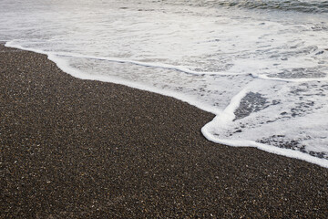 Ocean Wave on Rocky Beach Background