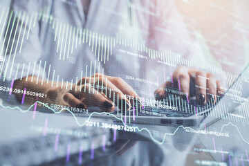 Double exposure of woman hands typing on computer and forex chart hologram drawing. Stock market invest concept.