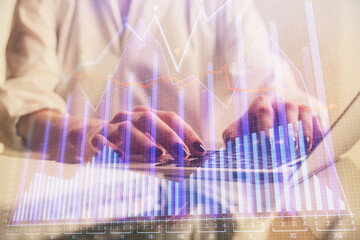 Double exposure of woman hands typing on computer and forex chart hologram drawing. Stock market invest concept.