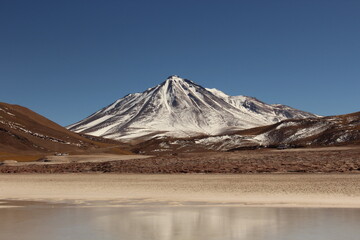 View of "Cainchique" Vulcan covered with snow from "Piedras Rojas" in Atacama Desert, Chile.