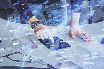 Double exposure of man's hand holding and using a digital device and data theme drawing. Technology concept.