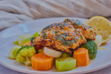Cod fillet on a bed of vegetables with a light sauce.