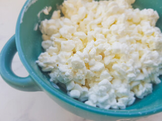 Cottage cheese grained close up in a plate