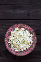 Jasmine in a metal old bowl on a dark wooden background. Fresh jasmine flowers picked in the garden. For tea or making essences, cooking, medical and cosmetology. Copy space for text