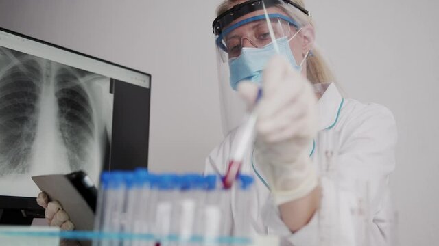 Scientists test for Covid-19 or Corona virus By using science tubes and tablet to research and treat illness in a laboratory or hospital. Medical treatment concepts