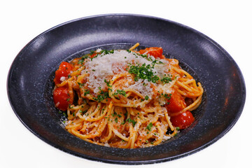 spaghetti pasta with rich creamy tomato sauce and grated parmeesan cheese in a serving bowl