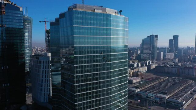 Aerial view of skyscraper and window cleaners in Warsaw city center