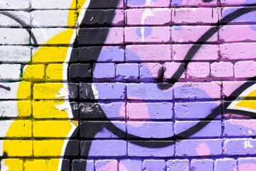 Color graffiti on a brick wall. Abstract grunge background