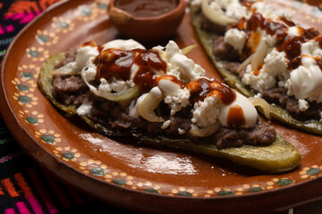 Mexican nopal cactus huaraches with cheese and beans on white background