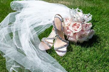 Bridal shoes hanging outdoors while bride getting ready for wedding marriage ceremony. Stylish, fancy and fashion elements of outfit.