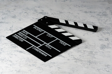 Clapper board with popcorn. Movie concept. Clapperboard on a textural background. Close-up. Copy...