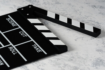 Clapper board with popcorn. Movie concept. Clapperboard on a textural background. Close-up. Copy...