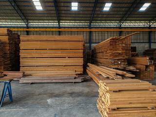 Lumber - Wood factory stock or timber in warehouse. ,Piles of wooden boards  waiting for shipping. Lumber, Business, production, manufacture and woodworking industry concept