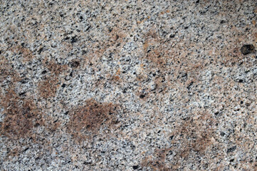 texture of a large river stone with different colored dots and fractions