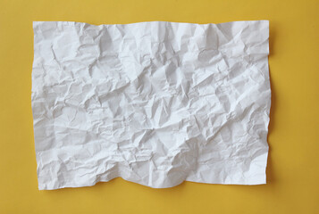 Obraz premium Crumpled paper isolated on yellow background .
