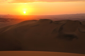Sand dunes near Huacachina at sunset, Ica region, Peru.