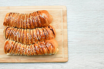 View from above of loaves of red bean bread on chopping board 