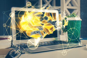 Double exposure of work space with computer and human brain drawing hologram. Brainstorm concept.