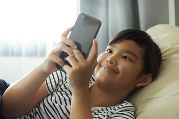 Little girl playing with the smartphone