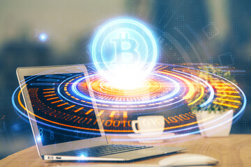 Multi exposure of blockchain theme hologram and table with computer background. Concept of bitcoin crypto currency.