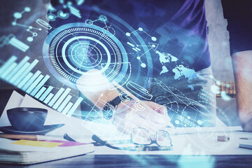 Double exposure of hands and notepad with business icons.
