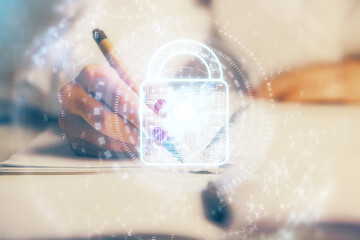 Double exposure of hands making notes with lock icons. Concept security and protection of data