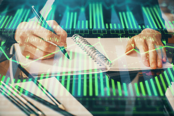 Double exposure of writing hands on background with data solution hologram on front. Technology concept. Close up