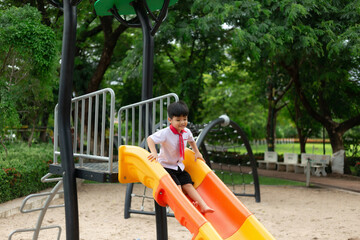 Happy cute little child playing in the park outdoors