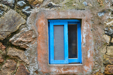 Fototapeta na wymiar Blue window frame of old house.