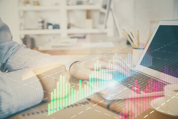 Multi exposure of stock market chart with man working on computer on background. Concept of financial analysis.