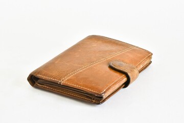 Old leather wallet isolated on a white background.