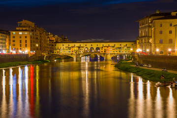 Fototapeta na wymiar Old Golden Bridge in the night landscape. Florence, Italy