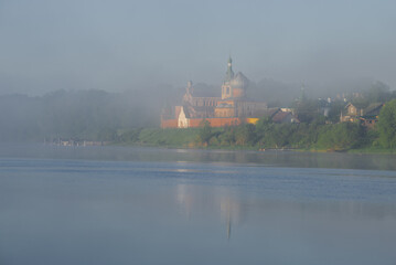 Foggy landscape with the Old Ladoga Nicholas Monastery in June early morning. Staraya Ladoga, Russia