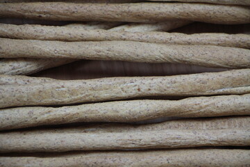 breadsticks, bread, rolls, pizza on wooden background