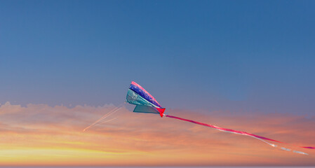 kite against sky during sunrise