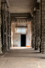 Fototapeta na wymiar Blured images of old Hindu temple with carving on pillars