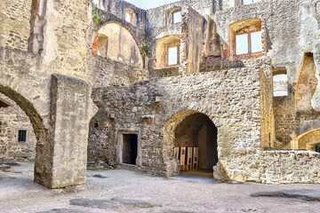 Fototapeta na wymiar Orava Castle - stone fortress from thirteenth century. Courtyard of a stone castle. Museum of ancient stone fortress. Thick walls, round entrances, window niches.