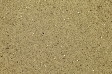 Beach sand texture. Overhead shot. Real plain beach sand surface wallpaper
