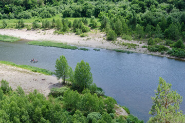 Fototapeta na wymiar Catamaran with tourists floating on Belaya river. Bashkiria national park, Bashkortostan, Russia.