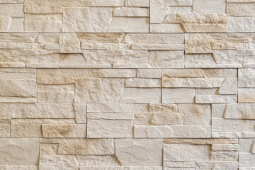 Obraz premium Decorative Stone Wall. Interior Stone Tiles Backdrop. Wall From Light Beige Decorative Stones