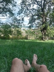 resting in nature wit feet in the grass