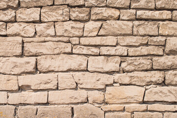 Old different size stone wall. Wall made from a natural stone. Stone wall texture as a solid background