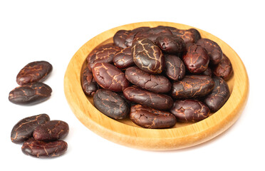 dried cocoa beans in the wooden bowl, isolated on white background