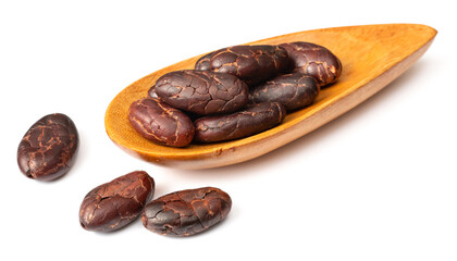 peeled cocoa beans in the wooden spoon, isolated on white background