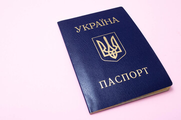 Ukrainian passport on a pink background. The passport of the citizen of Ukraine in the macro. Passport General plan and close-up